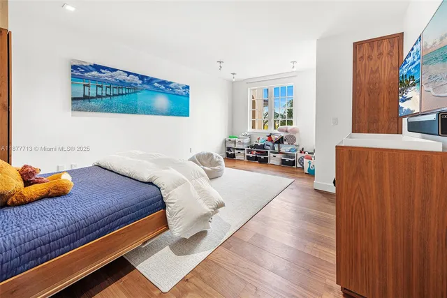 a bedroom with furniture and a wooden floor