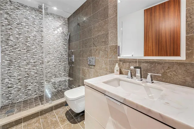 a bedroom with bed and a chandelier