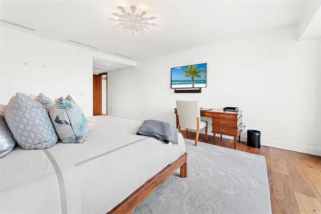 a living room with stainless steel appliances furniture and a kitchen view