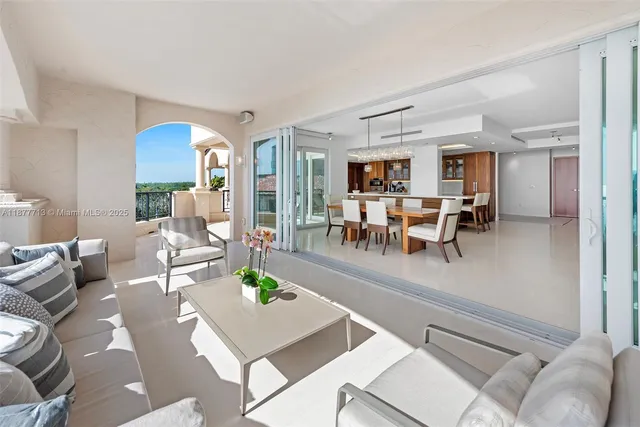 a view of a dining room with furniture a rug and wooden floor
