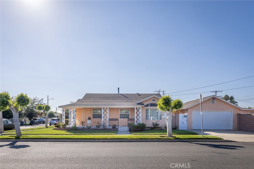 1001 West 134th Street Compton, CA 90222 - Photo 1 of 44 a front view of a house with a garden and trees