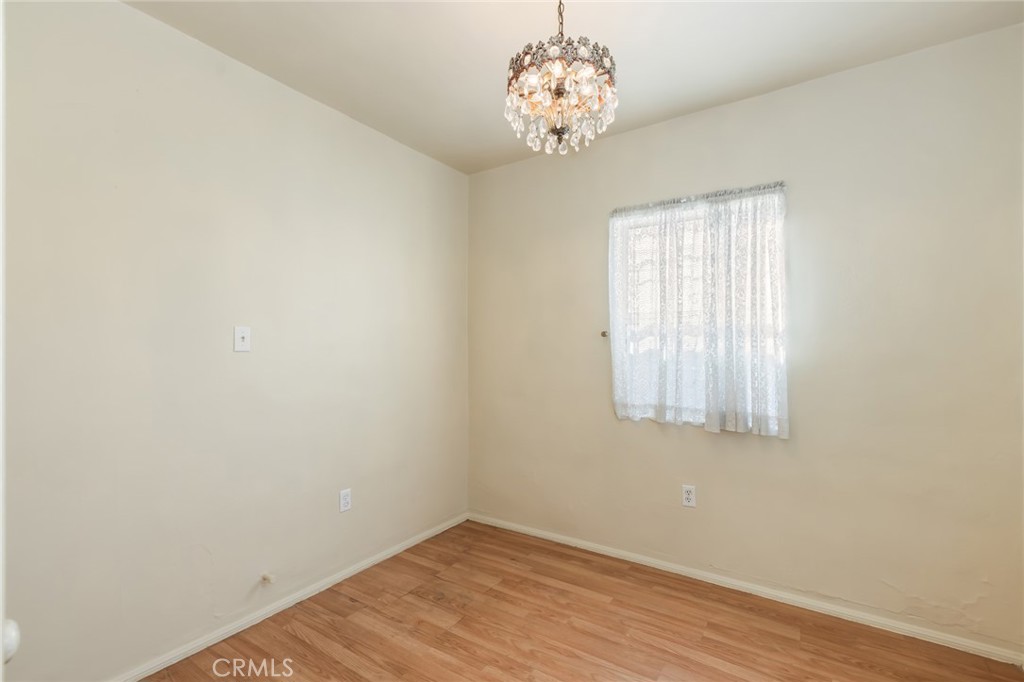 1001 West 134th Street Compton, CA 90222 - Photo 20 of 44 an empty room with wooden floor and windows