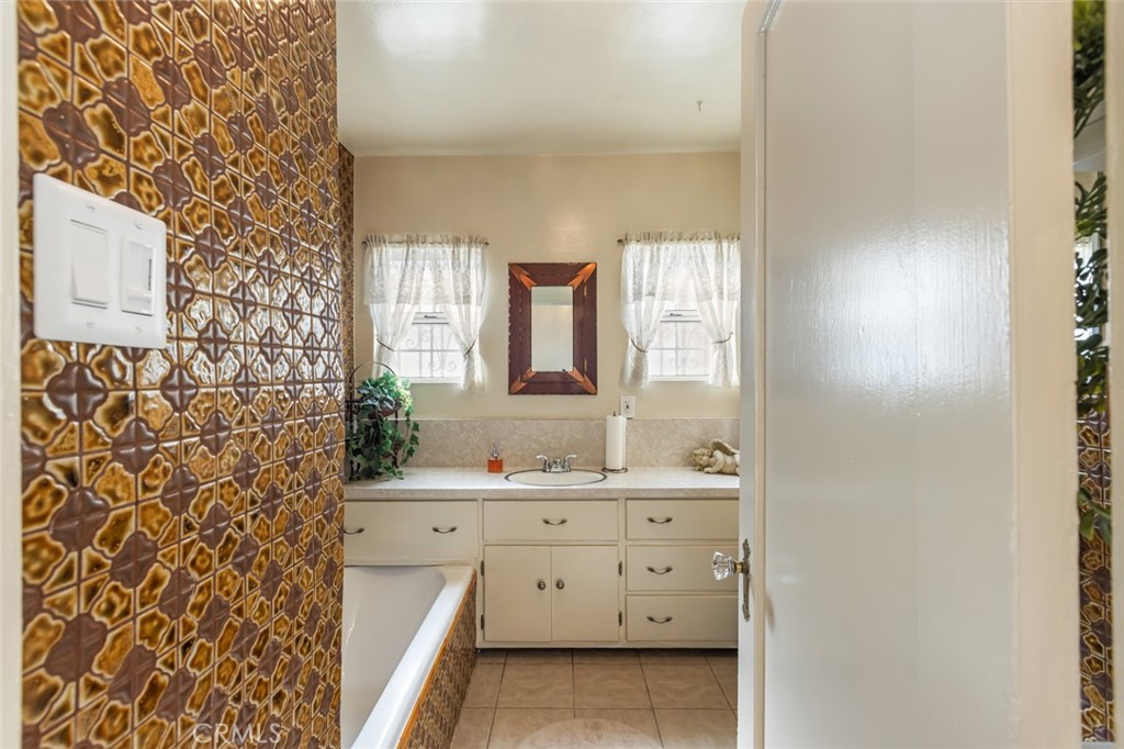 1001 West 134th Street Compton, CA 90222 - Photo 25 of 44 a bathroom with a double vanity sink and a mirror