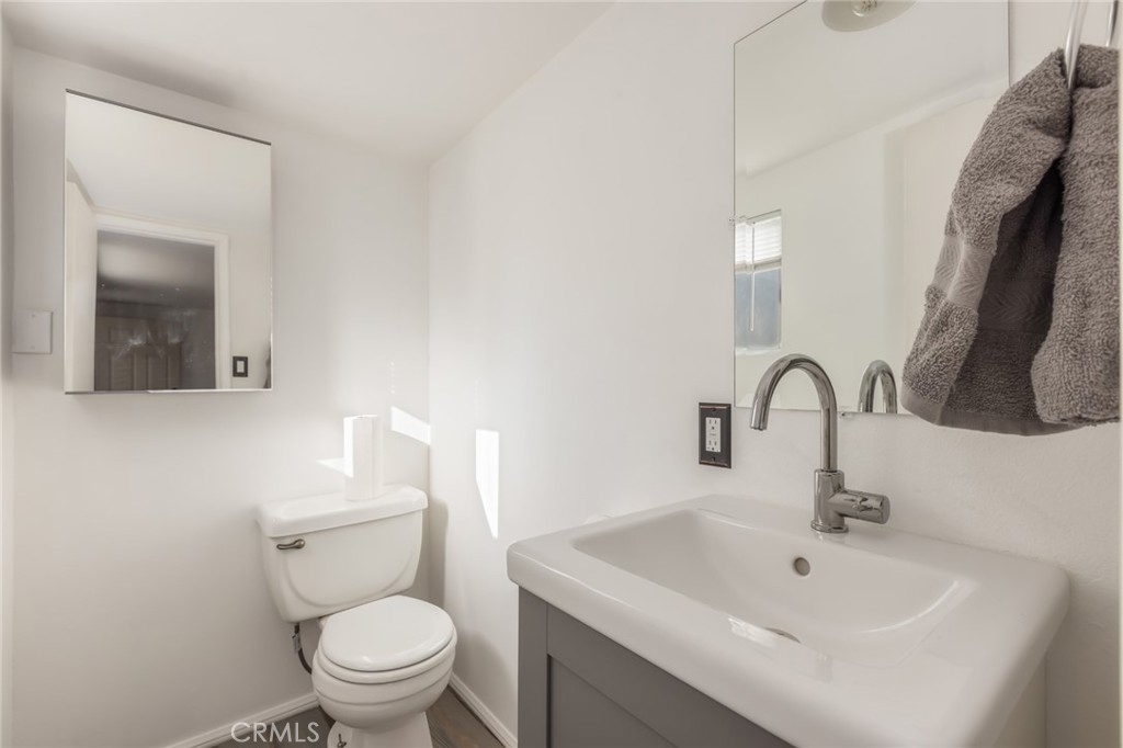 1001 West 134th Street Compton, CA 90222 - Photo 32 of 44 a bathroom with a sink a toilet and mirror