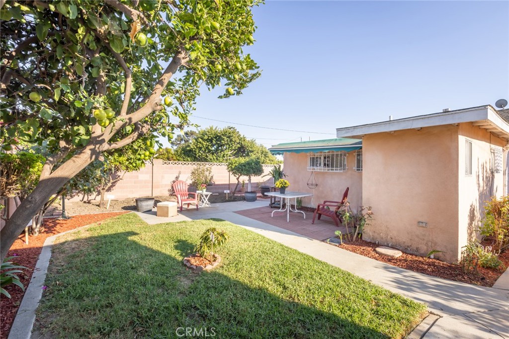 1001 West 134th Street Compton, CA 90222 - Photo 41 of 44 a view of a backyard with table and chairs under an umbrella
