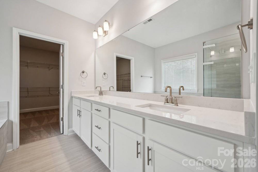 5041 Duval Circle Tega Cay, SC 29708 - Photo 26 of 47 a bathroom with double sink and a mirror