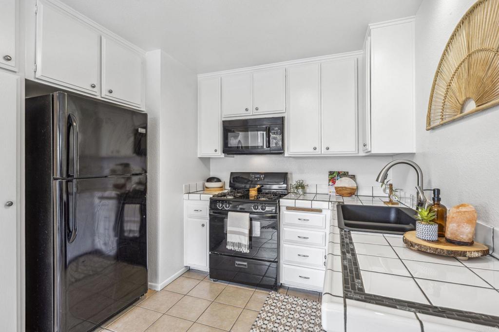 3431 Seabreeze Walk Oceanside, CA 92056 - Photo 12 of 23 a kitchen with stainless steel appliances granite countertop a refrigerator stove and sink
