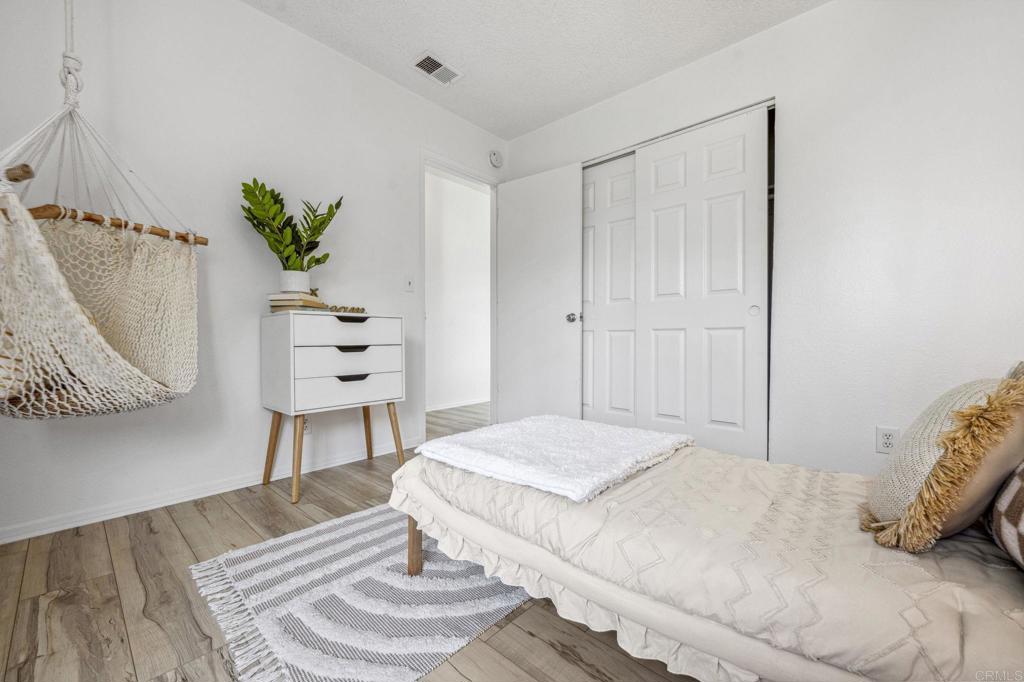 3431 Seabreeze Walk Oceanside, CA 92056 - Photo 15 of 23 a bedroom with a bed and a dresser