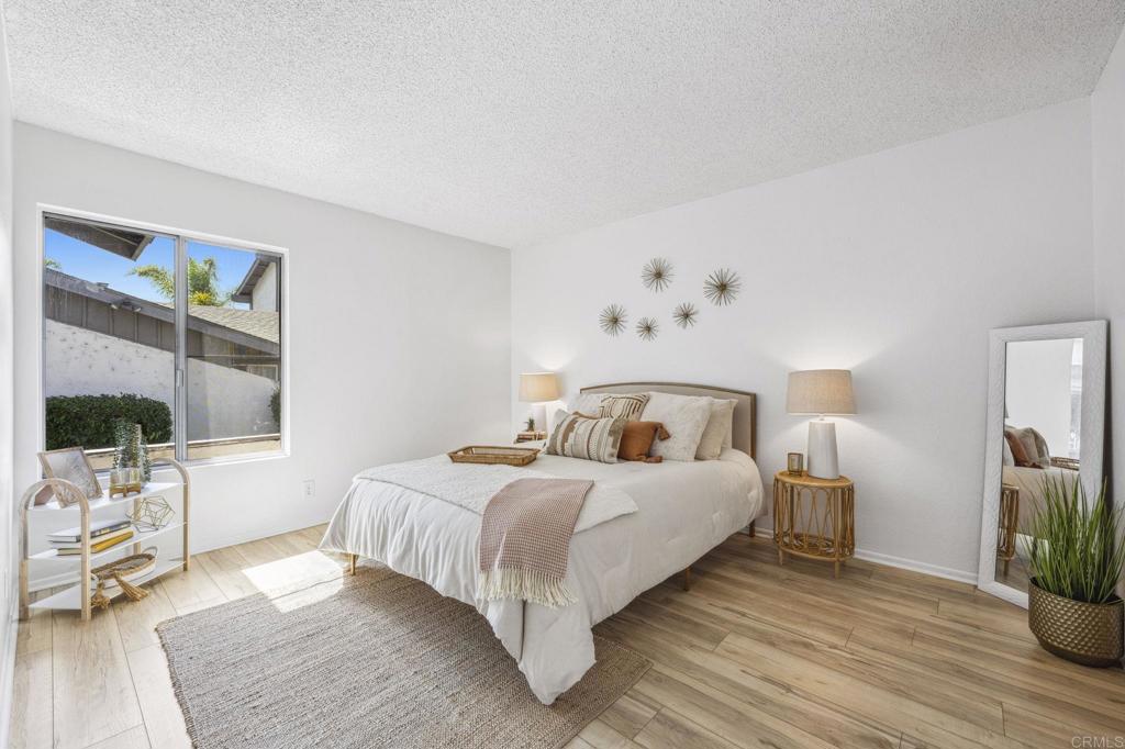 3431 Seabreeze Walk Oceanside, CA 92056 - Photo 17 of 23 a bedroom with a bed and wooden floor
