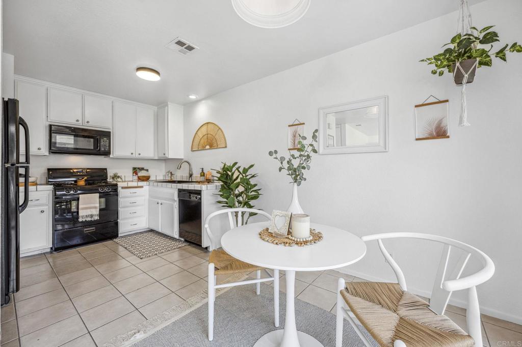 3431 Seabreeze Walk Oceanside, CA 92056 - Photo 5 of 23 a kitchen with stainless steel appliances granite countertop a table and chairs in it