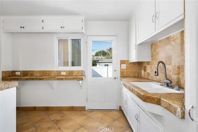 a bathroom with a sink a granite counter top and a stove