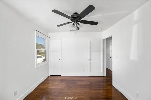 a view of a white house with a big yard and a large window
