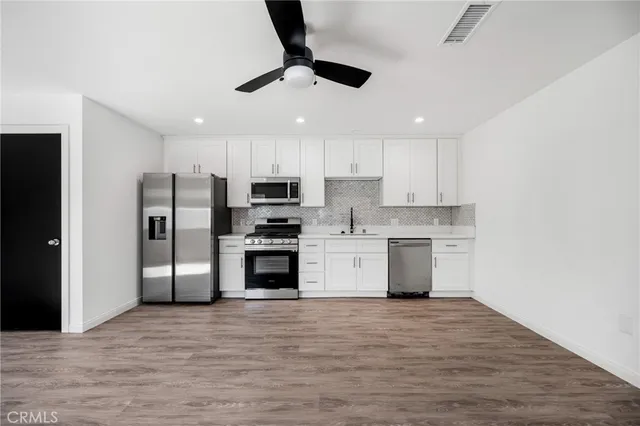 a kitchen with a sink cabinets and appliances