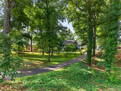 a view of a green field with lots of trees