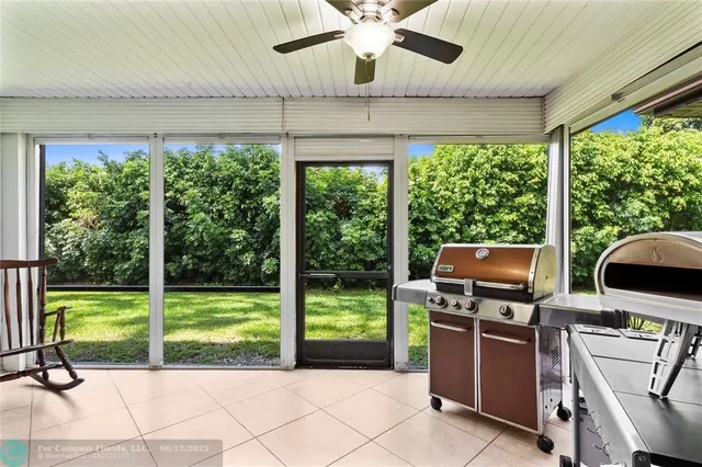 a view of an house with backyard space and balcony