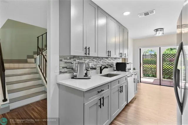 a kitchen with a sink cabinets and window