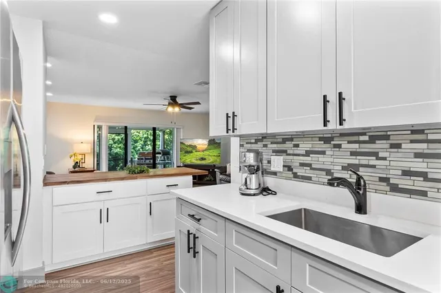 a kitchen with stainless steel appliances granite countertop a refrigerator and a stove top oven