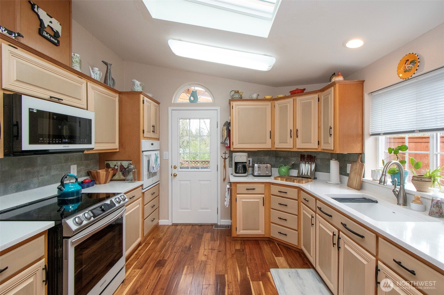 151 Green Meadows Drive Sequim, WA 98382 - Photo 14 of 40 a kitchen with a sink stove top oven and cabinets