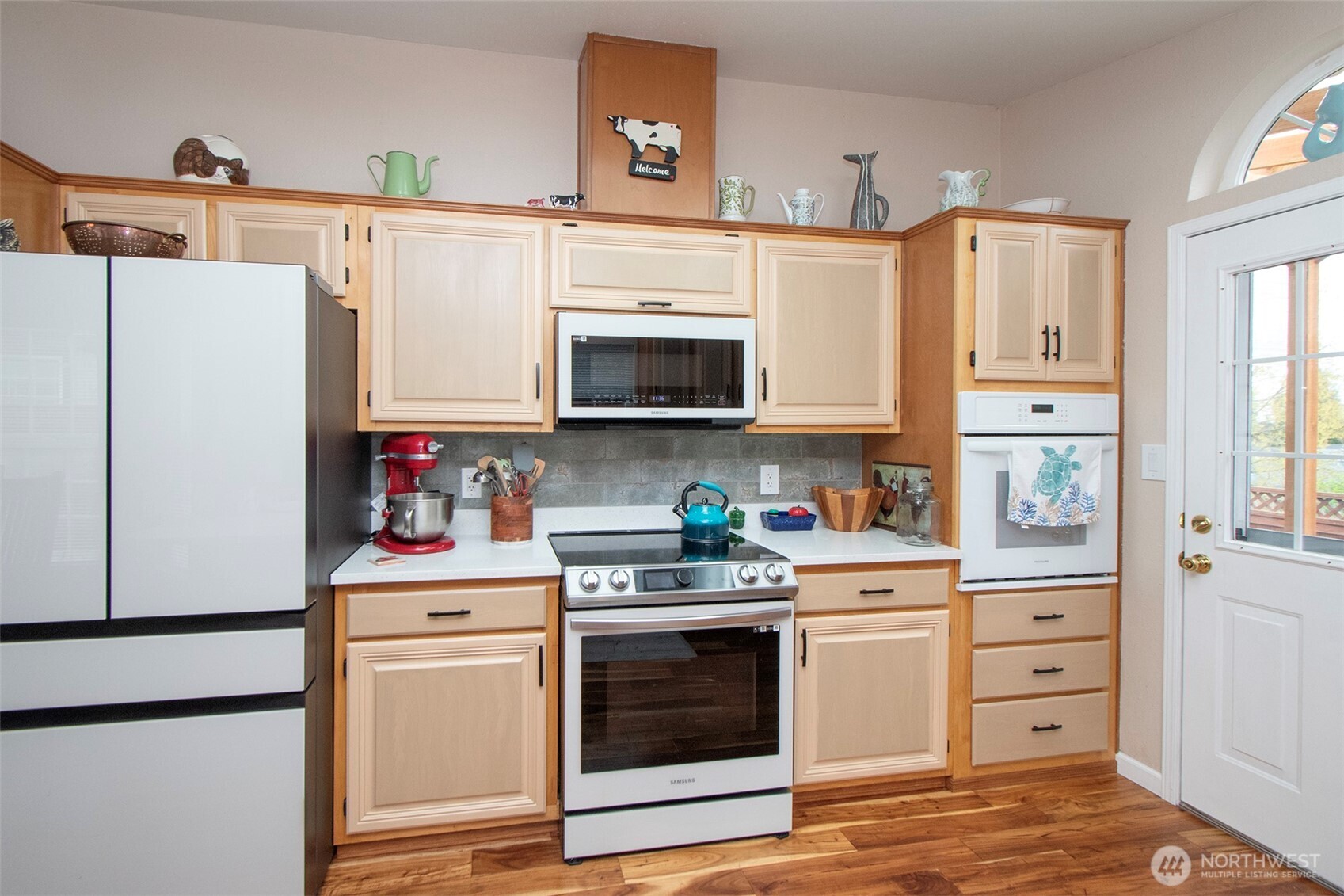 151 Green Meadows Drive Sequim, WA 98382 - Photo 15 of 40 a kitchen with stainless steel appliances granite countertop a refrigerator a stove a microwave and cabinets