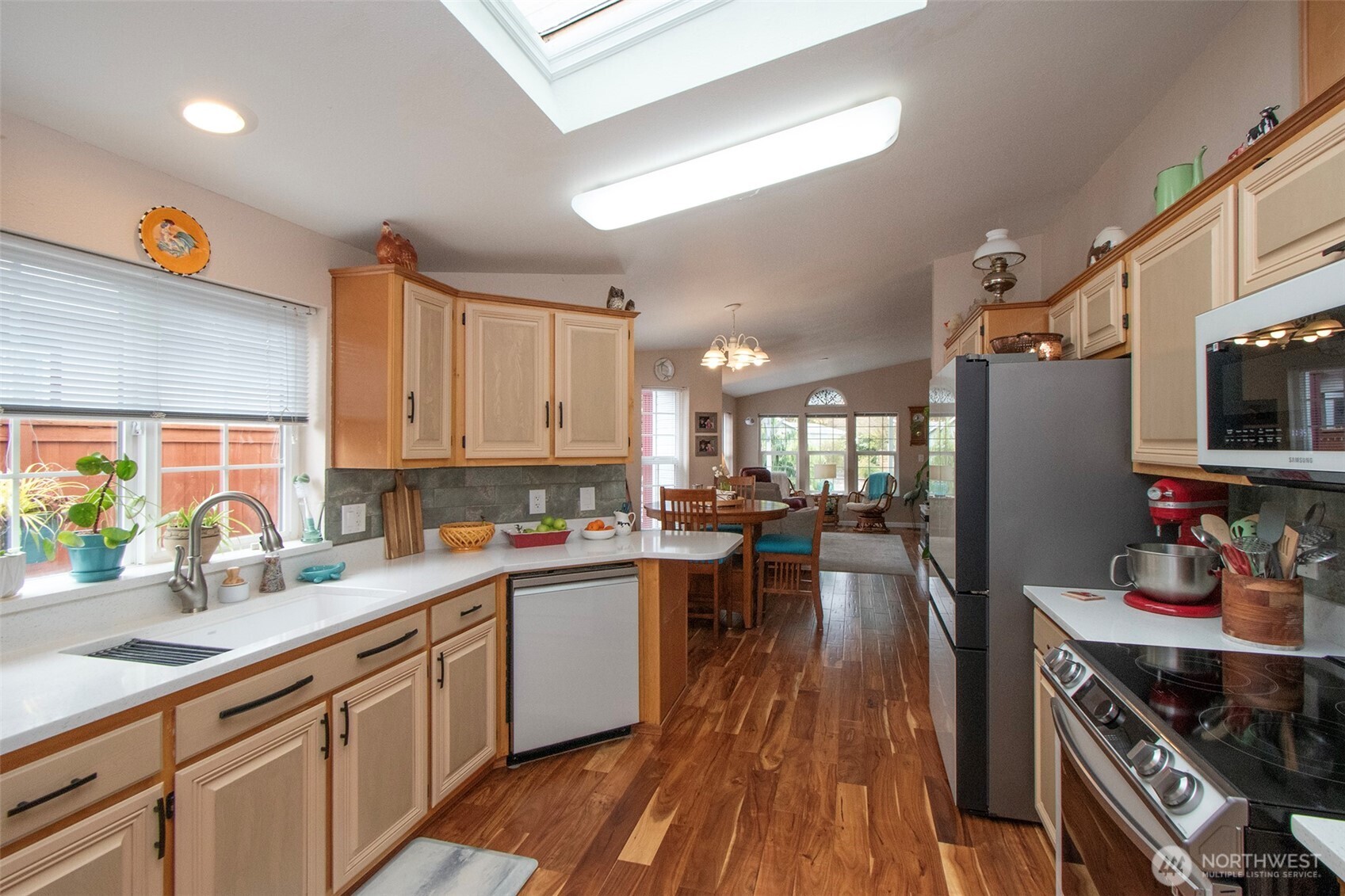 151 Green Meadows Drive Sequim, WA 98382 - Photo 16 of 40 a kitchen with lots of counter top space and wooden floor