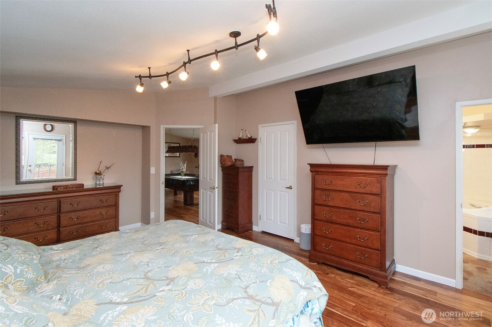 151 Green Meadows Drive Sequim, WA 98382 - Photo 19 of 40 a bedroom with a bed and a flat screen tv