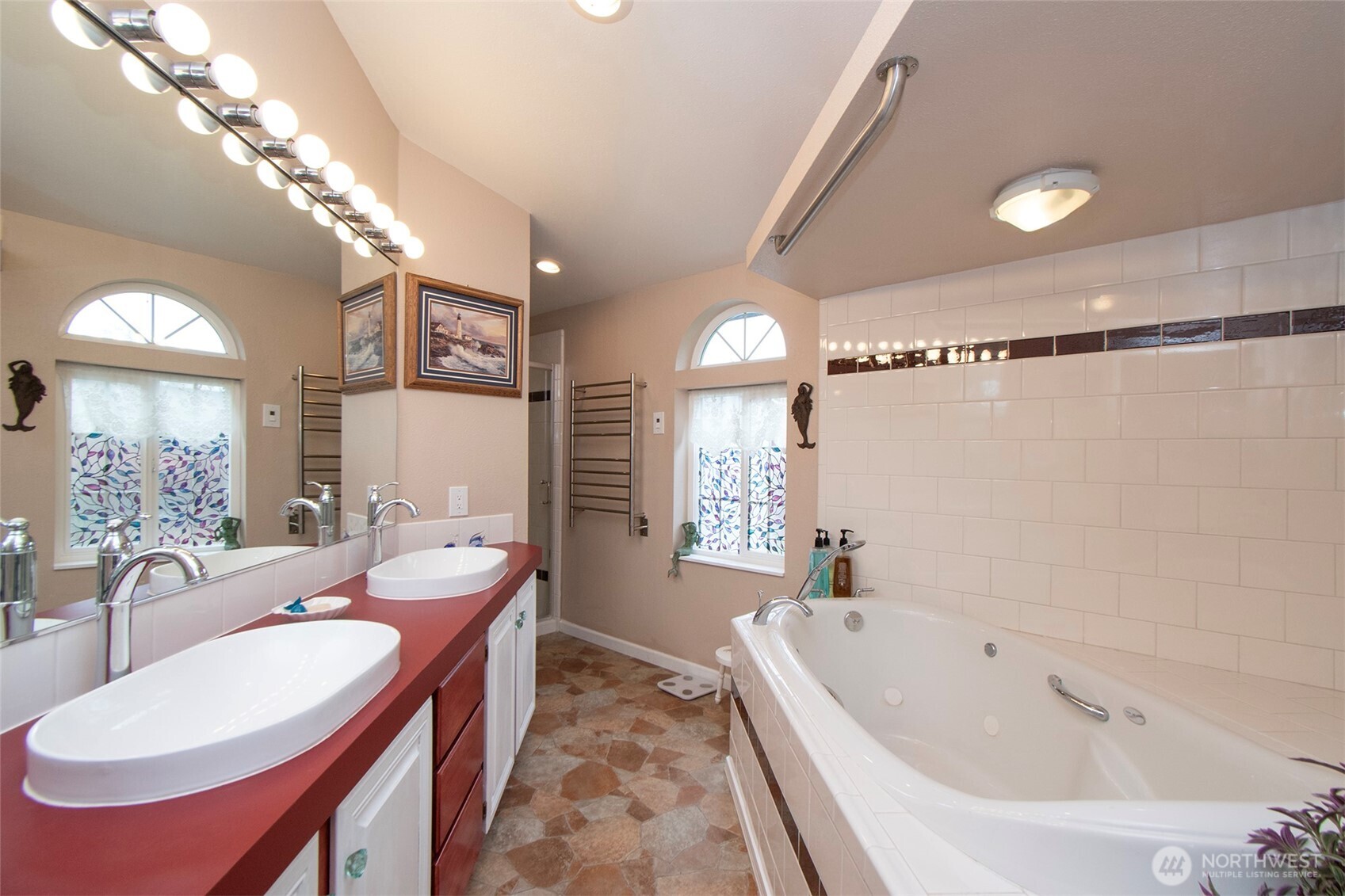 151 Green Meadows Drive Sequim, WA 98382 - Photo 20 of 40 a spacious bathroom with a double vanity sink a mirror and a bathtub