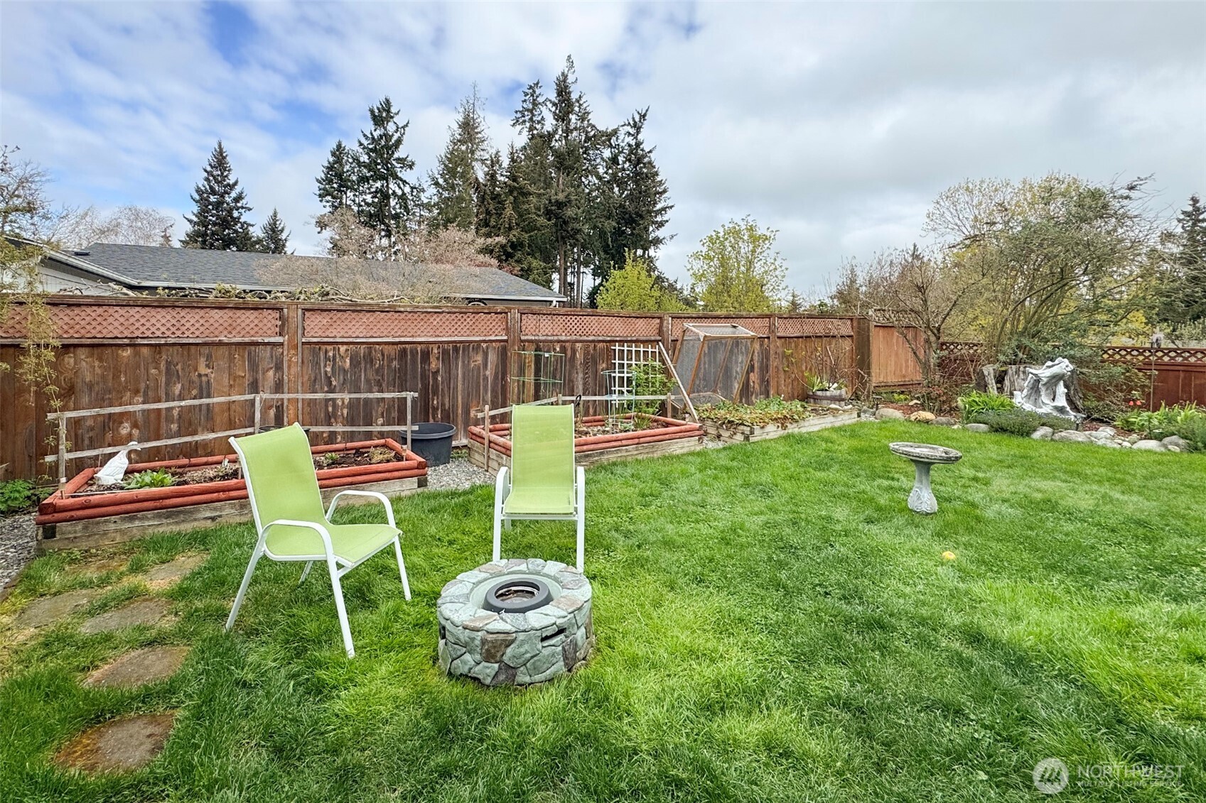 151 Green Meadows Drive Sequim, WA 98382 - Photo 34 of 40 a view of a backyard with table and chairs with wooden fence