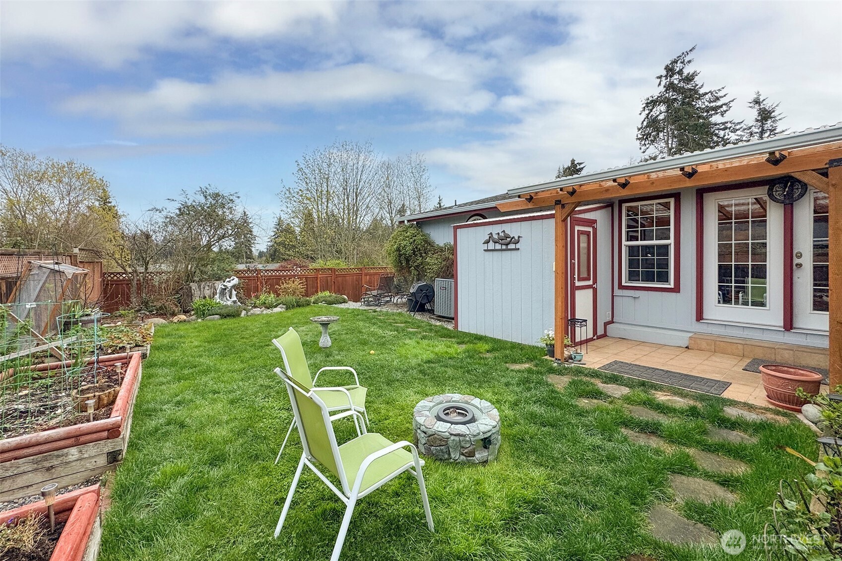 151 Green Meadows Drive Sequim, WA 98382 - Photo 35 of 40 a backyard of a house with table and chairs