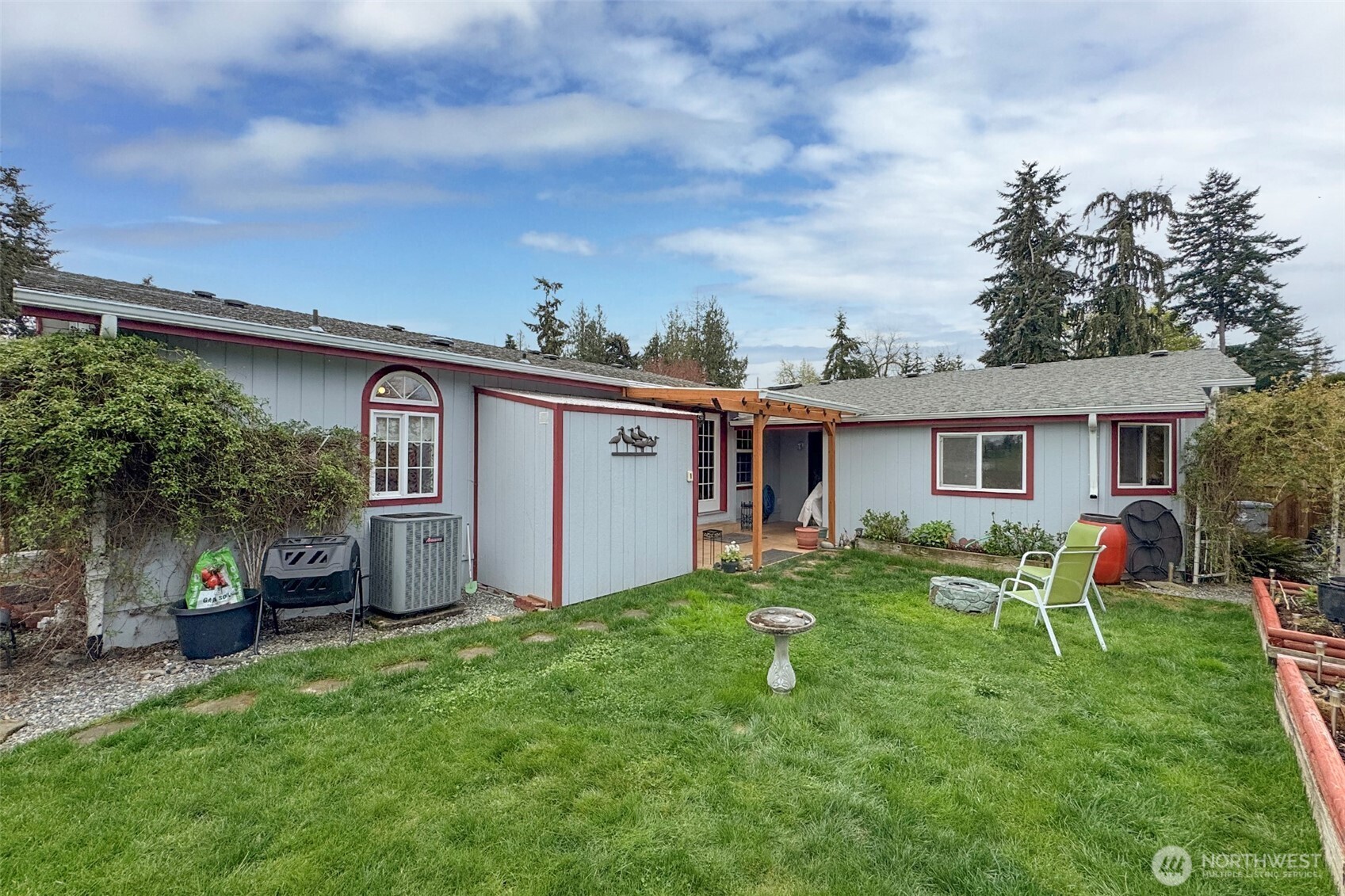 151 Green Meadows Drive Sequim, WA 98382 - Photo 40 of 40 a backyard of a house with table and chairs