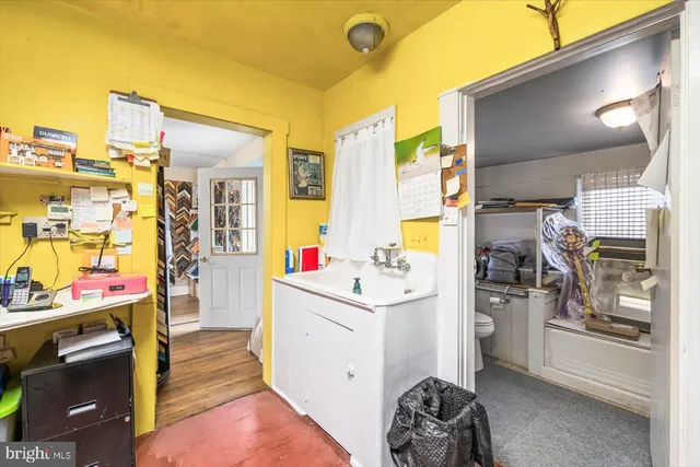 a bathroom with a sink mirror and a toilet