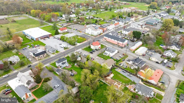 an aerial view of residential houses with outdoor space and trees
