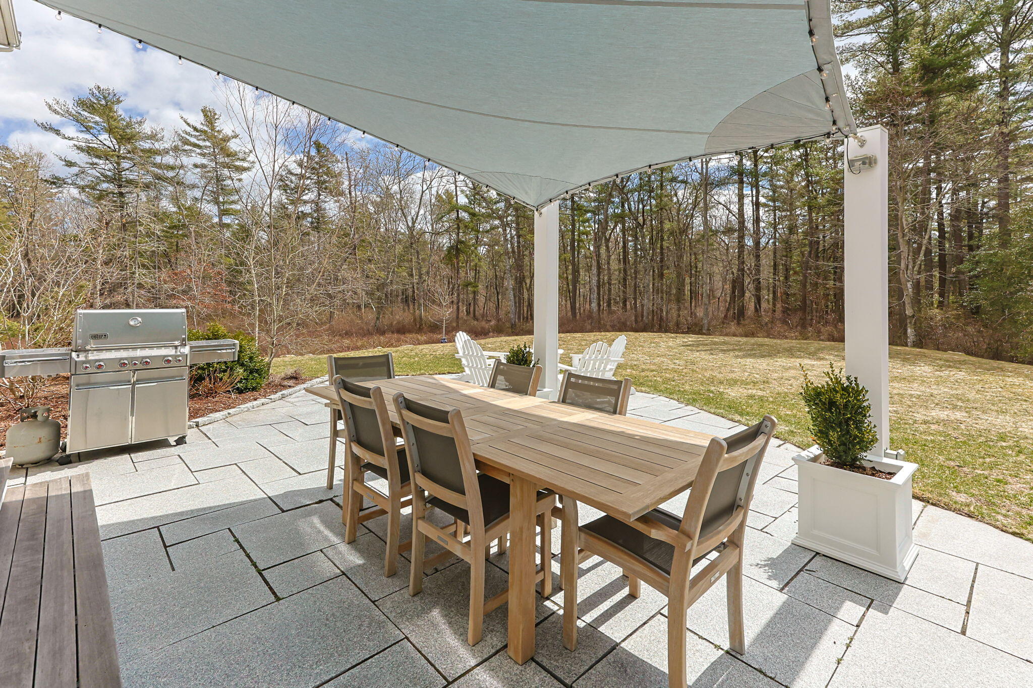 174 Cross Neck Road Marion, MA 02738 - Photo 37 of 41 a view of a patio with table and chairs with wooden floor and fence