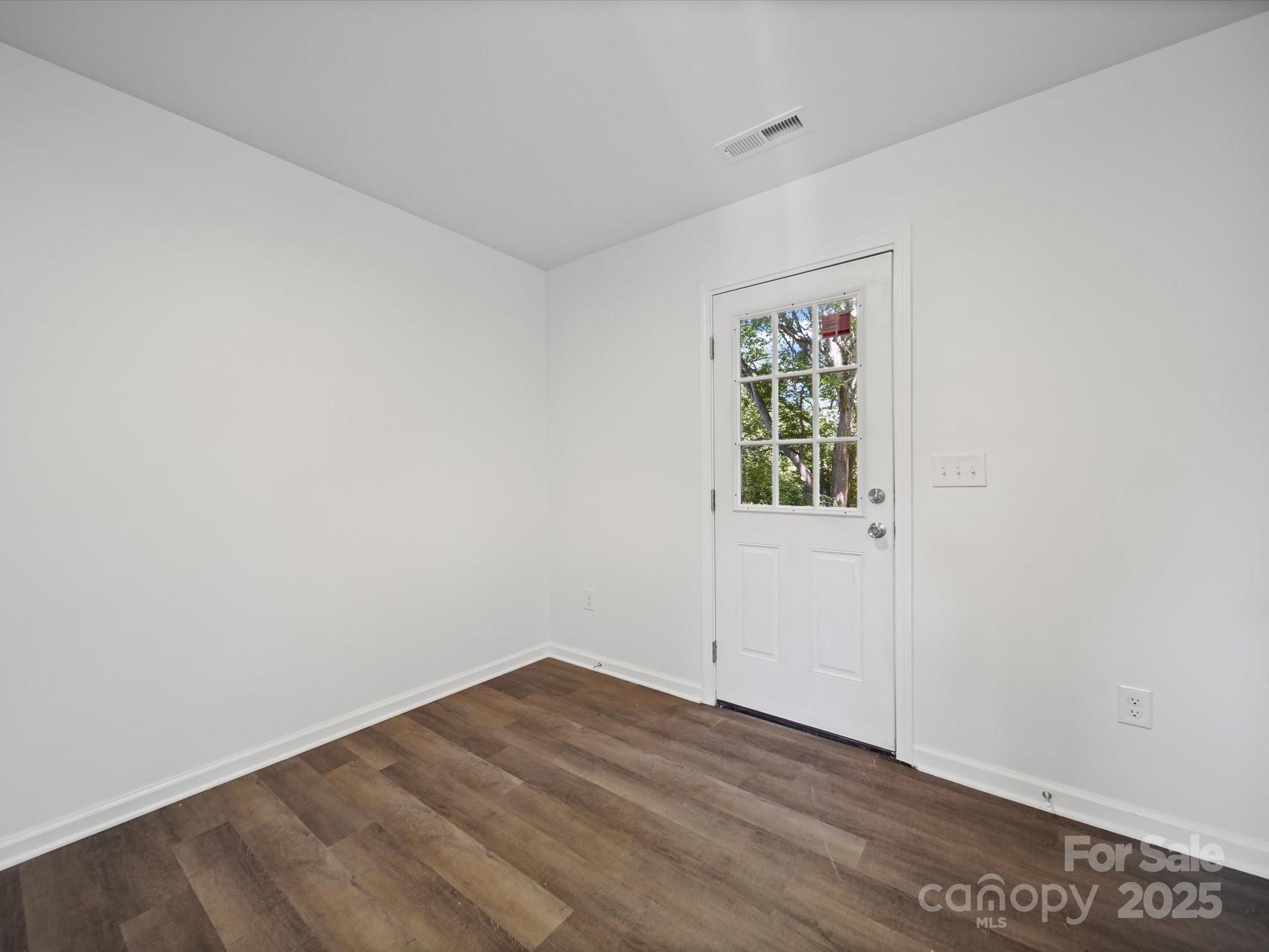 185 West End Street Chester, SC 29706 - Photo 13 of 26 a view of an empty room with wooden floor and a window