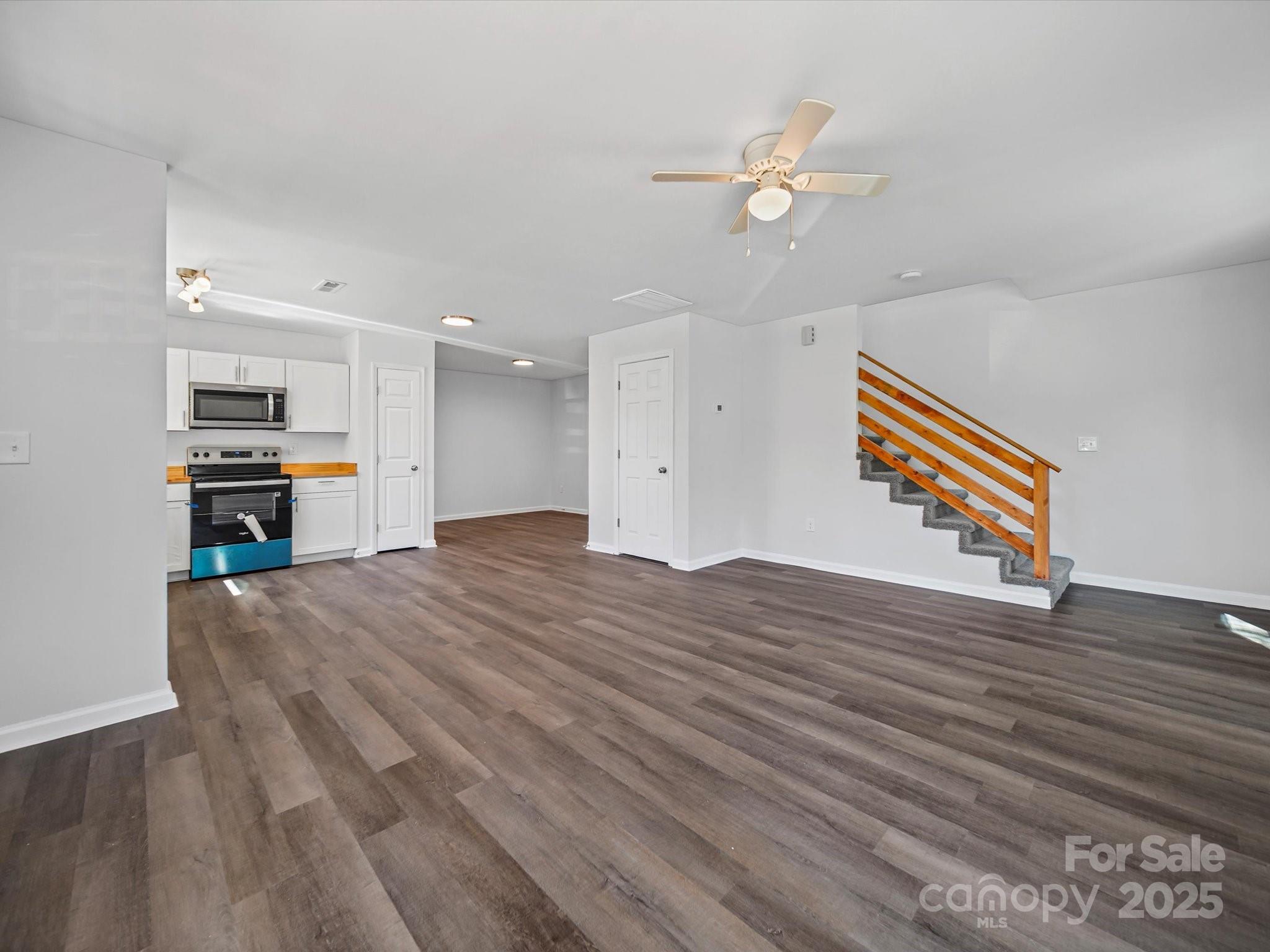 185 West End Street Chester, SC 29706 - Photo 7 of 26 a view of kitchen and empty room with wooden floor