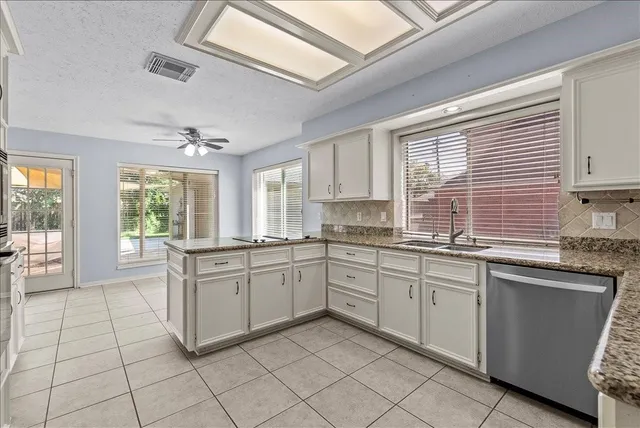 a kitchen with sink cabinets and window