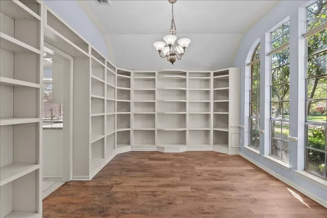 a view of a room with wooden floor and a window