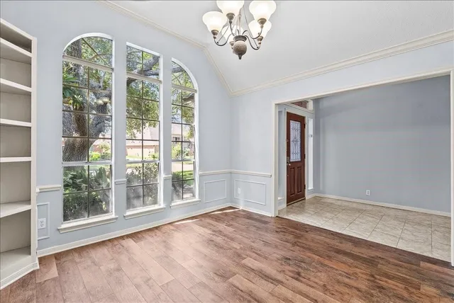 a kitchen with a cabinets and chandelier