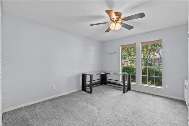a view of an empty room with a fan