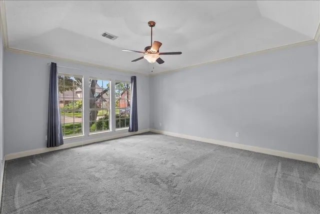 a spacious bathroom with a granite countertop sink a toilet a mirror and shower