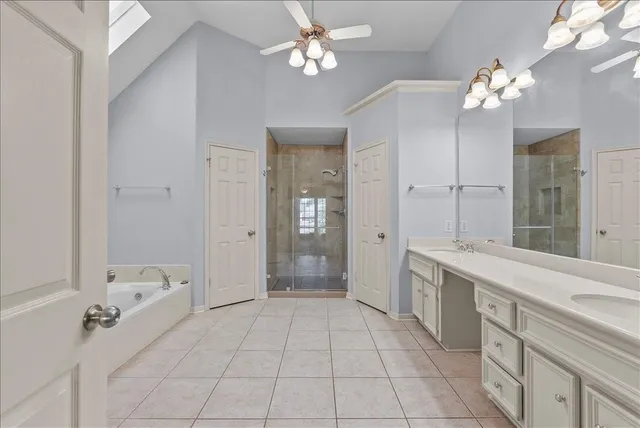 a spacious bathroom with a bathtub and closet