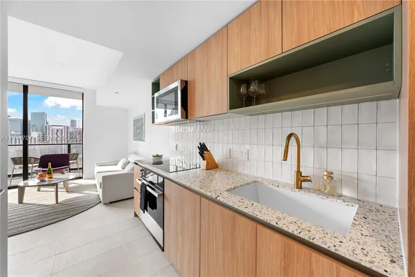 a kitchen with stainless steel appliances granite countertop a sink stove and cabinets