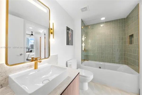 a bathroom with a bathtub shower sink and toilet