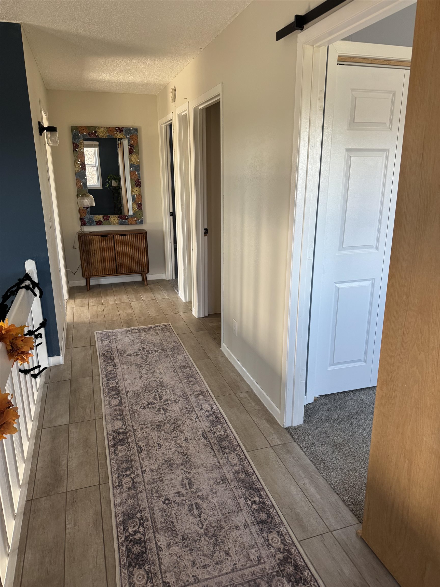 1217 North 33rd Street Superior, WI 54880 - Photo 13 of 21 Hall featuring a textured ceiling, a barn door, and wood finish floors