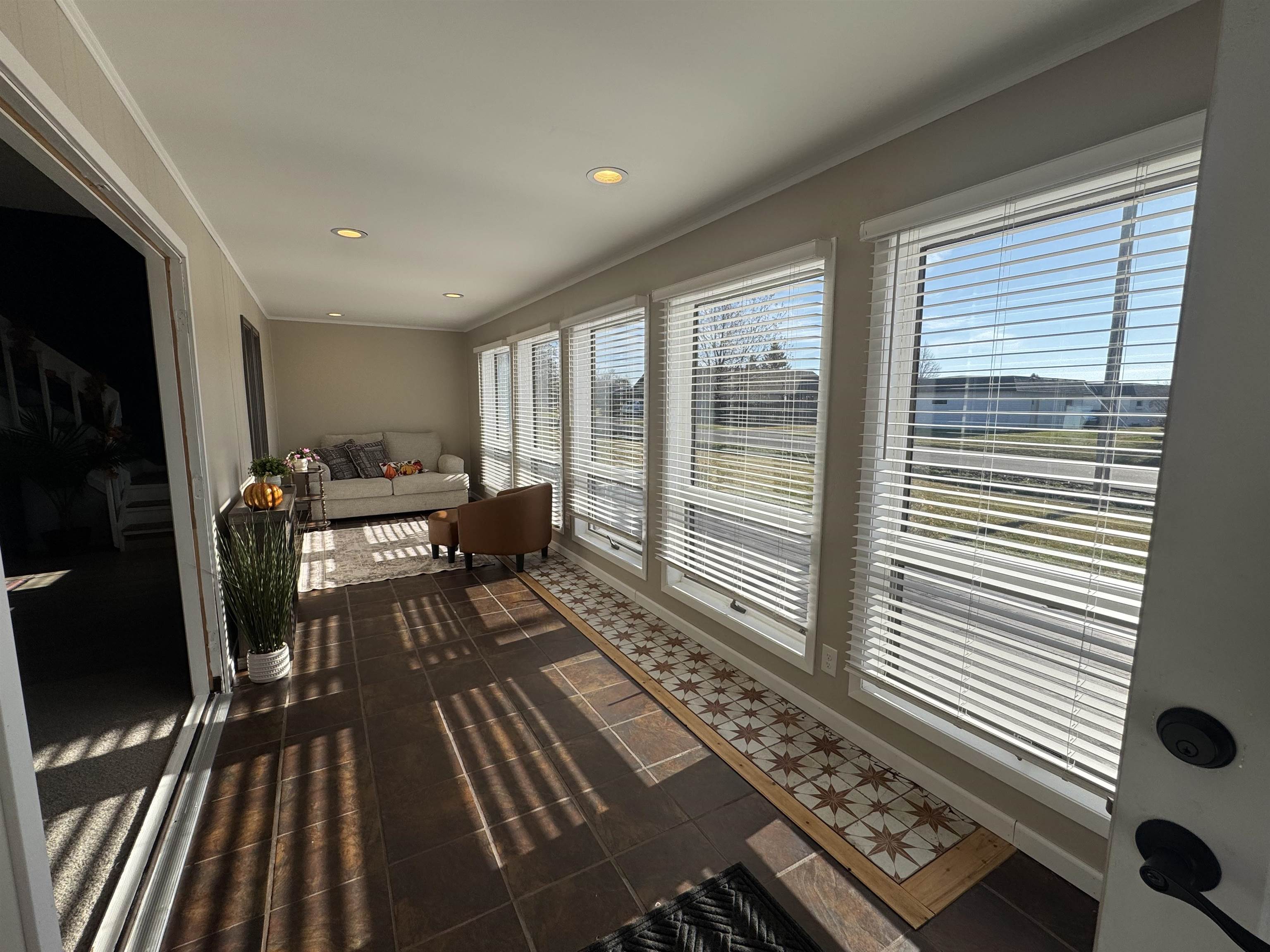 1217 North 33rd Street Superior, WI 54880 - Photo 2 of 21 Sunroom featuring crown molding, tile patterned floors, and recessed lighting