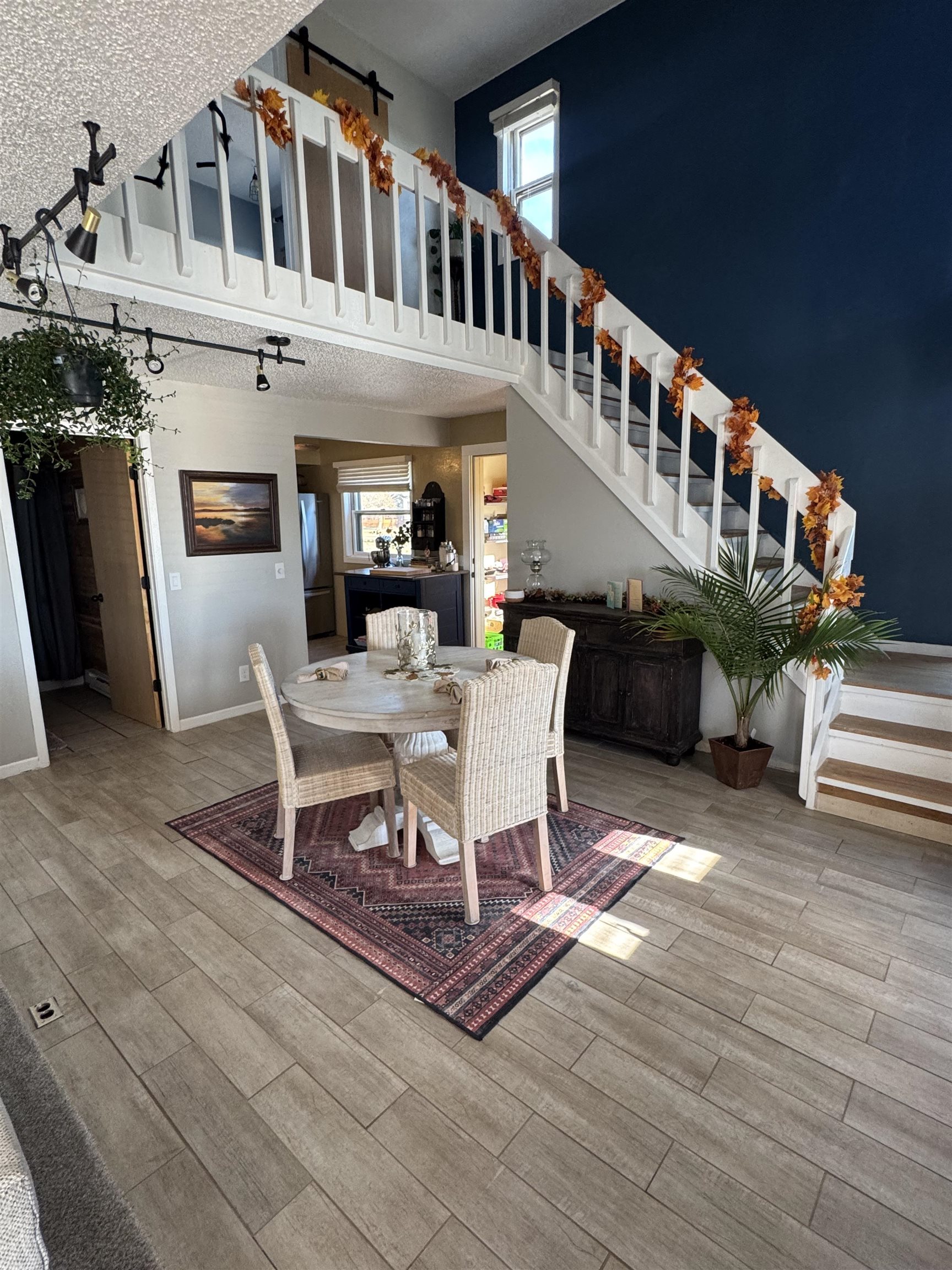 1217 North 33rd Street Superior, WI 54880 - Photo 7 of 21 Dining room featuring a towering ceiling, stairs, plenty of natural light, wood finished floors, and a textured ceiling