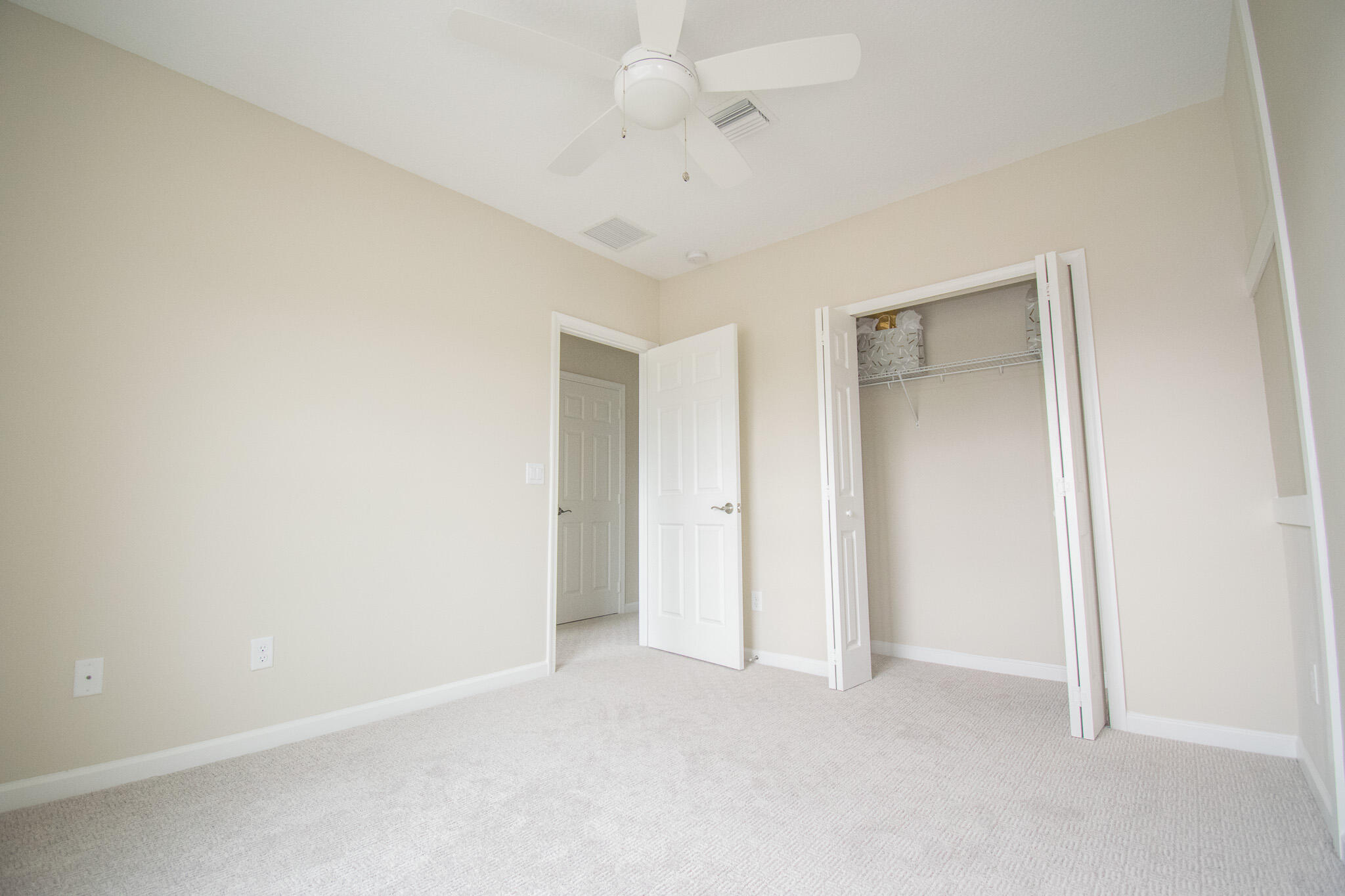 14426 Emerald Pl Way Delray Beach, FL 33484 - Photo 14 of 15 an empty room with a ceiling fan and carpet