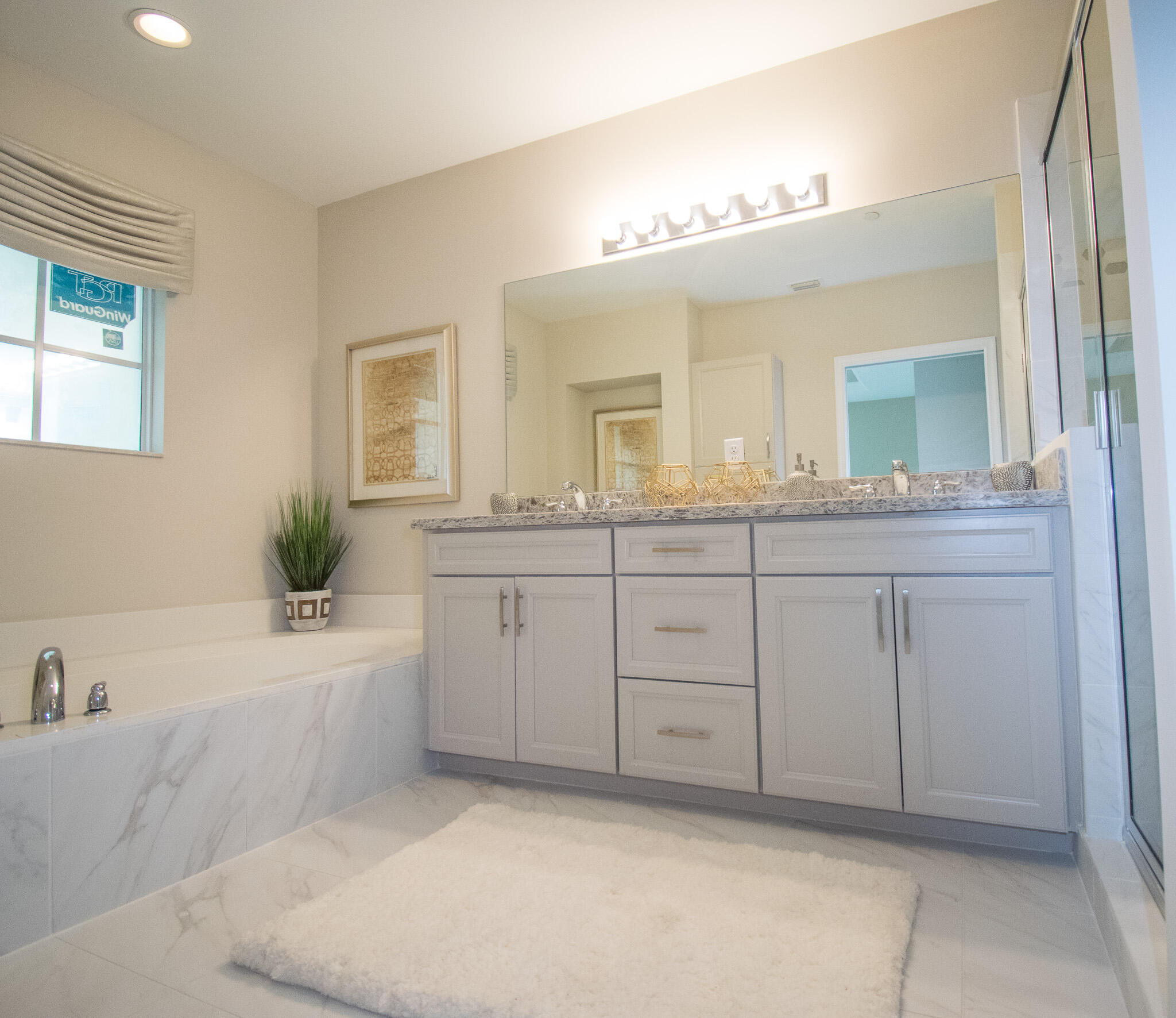 14426 Emerald Pl Way Delray Beach, FL 33484 - Photo 10 of 15 a bathroom with a sink a large mirror and a bathtub