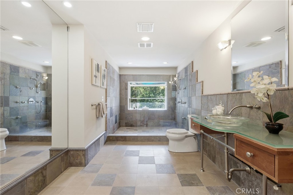 41 Hidden Valley Road Monrovia, CA 91016 - Photo 22 of 51 a bathroom with a granite countertop sink a toilet a mirror and shower
