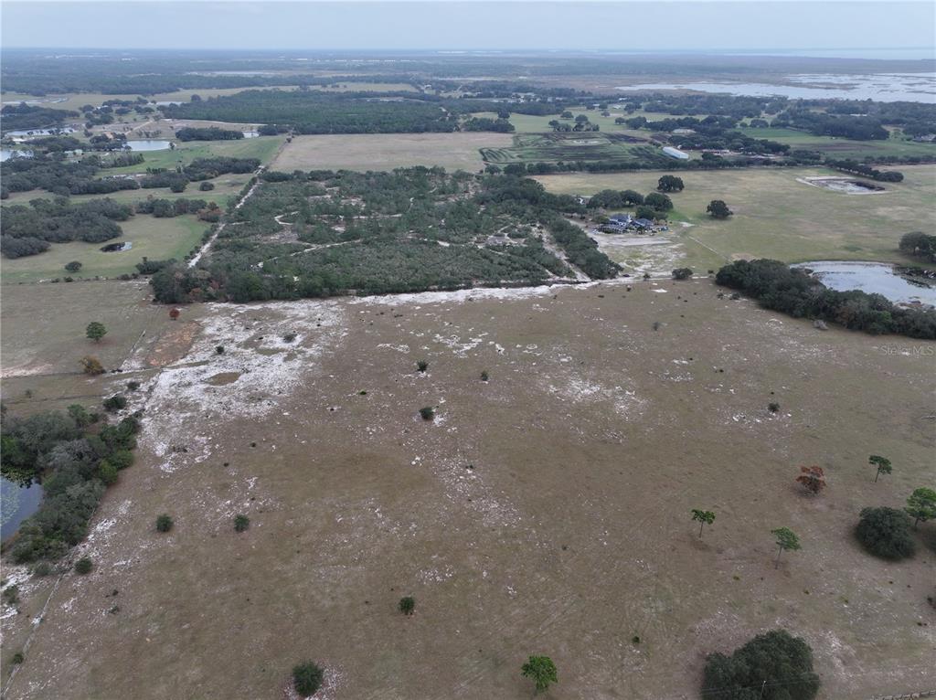 26049 Fair Street Astatula, FL 34705 - Photo 3 of 21 a view of a lake with beach and city view