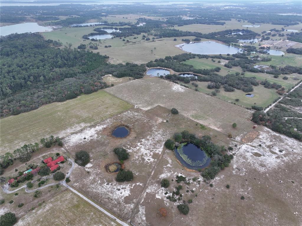 26049 Fair Street Astatula, FL 34705 - Photo 4 of 21 a view of a street with a view of a forest